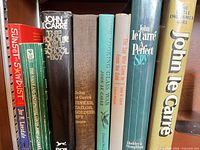 Spine view of eight novels on shelf