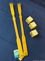 Two wooden back scratchers and three boxed bath bombs