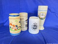 Front view of four ceramic beer steins