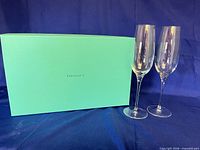 Tiffany blue box beside two crystal champagne flutes