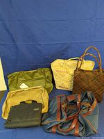 Group shot of all six bags arranged on blue backdrop