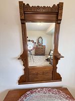 Full view of mirror showing frame design and shelves