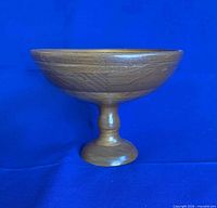 Side view of wooden pedestal bowl