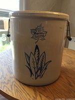 Front view showing maple leaf logo, plant motif, overall condition