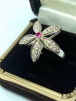 Top view of sterling silver flower ring in box
