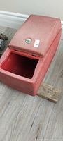 Closed red plastic console organizer side view