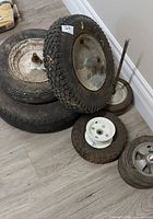 Group of assorted wheels and rims showing variety and condition