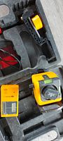 open carrying case showing laser level, detector and accessories