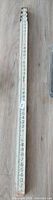Full view of the leveling rod showing measurement markings
