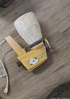 Left side view of Wagner W90 sprayer showing paint cup and power cord