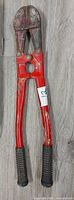 Full view of red bolt cutter on floor