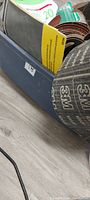 Tote edge with rolled 3M sanding belts and other abrasive sheets visible