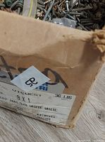 Close-up of box label showing size 9×1 and weight 36 lb with screws visible