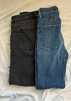 Both pairs folded side by side showing washes and pocket styles