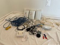 Overview of all items including cables, AirPods box, earbuds, charger, accessory packs