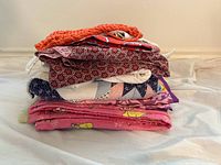Stack of assorted folded fabric pieces