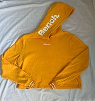 Front view of hoodie showing overall design, hood branding and chest logo