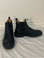 Both boots angled, showing uppers, pull tabs, elastic panels