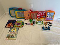 Overall view of lot showing drawing boards, electronic learning toys, flashlights and books