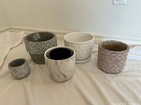 Group image of all five planter pots showing front and top profiles