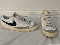 Full view of both sneakers showing uppers, suede toe caps, laces and side swoosh