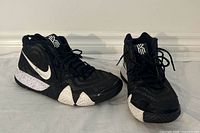 Front and top view of both shoes showing uppers, laces, tongue logos, and forefoot midsole detail
