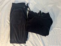 Hoodie folded and jogger pants laid flat showing color and fabric