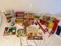 Full lot overview showing all wooden toys, puzzles, vehicles, blocks and instruments