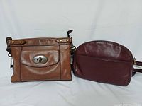Both Fossil leather crossbody bags side by side
