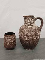 Front view of both fat lava vases showing texture and sizes