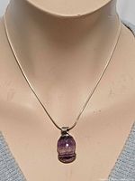 Full view of necklace on bust showing chain length and pendant