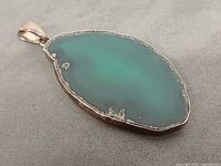 Front view of pendant showing agate slice and silver bezel