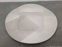 Top view of round stainless steel platter with recessed square