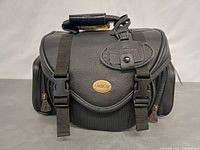 Front view showing Ambico logo, buckle straps, top handle