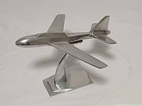 side view of polished aluminium airplane sculpture showing fuselage and wings