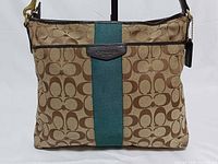 Front view of Coach khaki jacquard messenger showing green stripe and leather trim