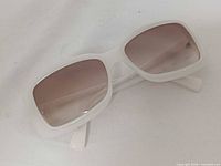 Front angled view of white Giorgio Armani GA 511/S sunglasses showing frame and lenses