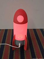 Lamp lit pink showing front profile and cable