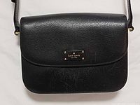 Front view showing logo plaque and leather texture