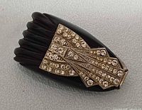 Front view showing carved black Bakelite body and rhinestone overlay