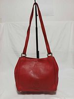 Front view of red Bally leather shoulder bag on stand