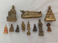 All eleven miniature Buddhist figures displayed in two rows on neutral background