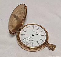 Open hunter pocket watch showing dial and case
