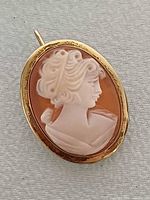 Front view of gold-filled shell cameo brooch pendant