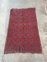 Full view of red Torkoman rug showing overall design and size