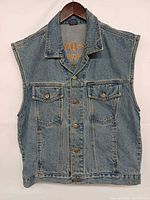 Front view of sleeveless Harley-Davidson denim vest showing button front and chest pockets