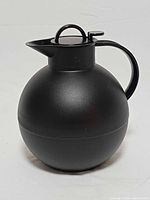 Front view of matte black spherical Alfi Kugel carafe showing handle and lid