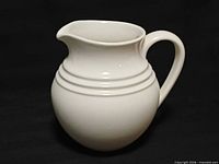 Front view of white ceramic Dansk Century pitcher showing full profile and handle