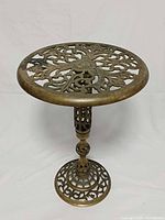 Full view of brass pedestal plant stand showing height and ornate design