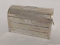 Front view showing coin slot, keyhole plate and wood-grain texture